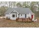 Inviting rear exterior features a wooden deck, bay window, and a cozy outdoor seating area at 2629 Sweetgum Dr, Apex, NC 27539