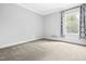 Empty bedroom with neutral colors and carpet and a natural light window at 270 Trailing Bluff Way, Garner, NC 27529