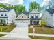 Exterior elevation of the two-story home with attached two-car garage and a well-manicured lawn at 270 Trailing Bluff Way, Garner, NC 27529