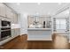 Modern kitchen featuring an island, stainless steel appliances, and ample countertop space at 270 Trailing Bluff Way, Garner, NC 27529