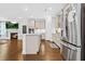 Modern kitchen with stainless steel appliances, a large island, and views to the cozy fireplace at 270 Trailing Bluff Way, Garner, NC 27529