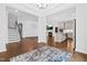 Open living area with hardwood floors, modern staircase, and seamless transition to a contemporary kitchen at 270 Trailing Bluff Way, Garner, NC 27529