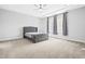 Elegant main bedroom featuring a tray ceiling, ceiling fan, and upholstered headboard at 270 Trailing Bluff Way, Garner, NC 27529