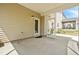 View of the screened in porch with concrete flooring and a door to the home's exterior at 270 Trailing Bluff Way, Garner, NC 27529