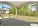 View of the screened porch with concrete flooring and backyard views, and a door to outside at 270 Trailing Bluff Way, Garner, NC 27529