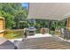 Outdoor deck with grill and canvas shade, ideal for entertaining and outdoor dining at 2832 Steeple Run Dr, Wake Forest, NC 27587