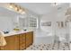 Bright bathroom featuring double vanity, soaking tub, and a separate shower area with white tiling at 2832 Steeple Run Dr, Wake Forest, NC 27587
