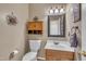 Charming half bathroom featuring wooden vanity and cabinet, decorative mirror, and a toilet at 2832 Steeple Run Dr, Wake Forest, NC 27587