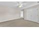 Bedroom with carpet flooring, featuring double closets, a ceiling fan, and a neutral color scheme at 2832 Steeple Run Dr, Wake Forest, NC 27587