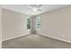 Neutral bedroom with two windows covered by decorative curtains and plush carpeting at 2832 Steeple Run Dr, Wake Forest, NC 27587