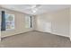 Spacious bedroom with neutral walls, plush carpet, and natural light from two large windows at 2832 Steeple Run Dr, Wake Forest, NC 27587