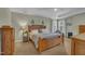 Relaxing bedroom with tray ceiling, complemented by neutral walls, soft carpet, and well-lit windows at 2832 Steeple Run Dr, Wake Forest, NC 27587