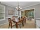 Inviting dining room with a wooden table, six chairs, and a clear view to the living room at 2832 Steeple Run Dr, Wake Forest, NC 27587