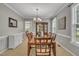 Elegant dining room featuring a large wooden table, decorative chandelier, and neutral wall color at 2832 Steeple Run Dr, Wake Forest, NC 27587