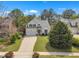 Charming two-story home with a well-manicured lawn, mature landscaping, and a paved driveway at 2832 Steeple Run Dr, Wake Forest, NC 27587