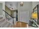 Open foyer showcasing hardwood floors, a white door, and a view into the living room at 2832 Steeple Run Dr, Wake Forest, NC 27587