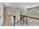 Upstairs foyer with railing overlooks the living room and features unique arched window at 2832 Steeple Run Dr, Wake Forest, NC 27587