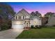 Charming two-story home with mature trees, attached garage, and well-manicured lawn at 2832 Steeple Run Dr, Wake Forest, NC 27587
