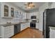 Spacious kitchen features white cabinets, granite countertops, stainless steel appliances, and hardwood floors at 2832 Steeple Run Dr, Wake Forest, NC 27587
