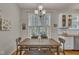 Eat-in kitchen features a rustic wooden dining table and chairs and large window with natural light at 2832 Steeple Run Dr, Wake Forest, NC 27587