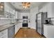 Updated kitchen boasts stainless steel appliances, white cabinets, granite countertops, and hardwood floors at 2832 Steeple Run Dr, Wake Forest, NC 27587