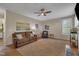 Cozy living room featuring hardwood floors, a plush sofa, and natural light from a large window at 2832 Steeple Run Dr, Wake Forest, NC 27587
