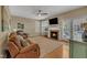 Comfortable living room with a fireplace, plush seating, and hardwood floors at 2832 Steeple Run Dr, Wake Forest, NC 27587