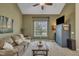 Comfortable living room with neutral carpet, a modern ceiling fan, and a large window at 2832 Steeple Run Dr, Wake Forest, NC 27587