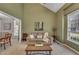 Cozy living room with neutral carpet, a comfortable couch, and large windows for natural light at 2832 Steeple Run Dr, Wake Forest, NC 27587