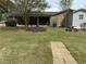 Spacious backyard with a stone walkway and garden, ideal for outdoor entertaining at 2886 Steven'S Chapel Rd, Smithfield, NC 27577