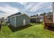 Green backyard featuring a storage building with a white door at 304 Rivella Dr, Wake Forest, NC 27587