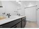 Modern bathroom with a dual sink vanity, matte black fixtures, and bright white tile at 304 Rivella Dr, Wake Forest, NC 27587
