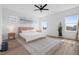 Sunlit bedroom with natural textures including a jute bedframe, with two side tables and a blue rug at 304 Rivella Dr, Wake Forest, NC 27587