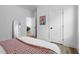 Bright bedroom with a cozy bed with a rose-colored blanket, and view of a doorway at 304 Rivella Dr, Wake Forest, NC 27587