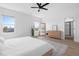 Bright bedroom with a woven bedframe, large mirror, and en suite bathroom at 304 Rivella Dr, Wake Forest, NC 27587