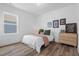 Cozy bedroom features a white bed, a window with neighborhood views, and a light wood dresser at 304 Rivella Dr, Wake Forest, NC 27587
