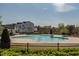 Inviting community pool area with a spacious sundeck, lounge chairs, and nearby residential buildings at 304 Rivella Dr, Wake Forest, NC 27587
