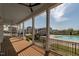 Relaxing covered porch with ceiling fans, offering views of the community pool and landscaped surroundings at 304 Rivella Dr, Wake Forest, NC 27587