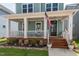 Cozy covered front porch with wood decking and views of landscaped yard at 304 Rivella Dr, Wake Forest, NC 27587