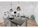 Kitchen island featuring pendant lighting, seating, and views into other living spaces at 304 Rivella Dr, Wake Forest, NC 27587