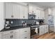 Modern kitchen featuring stainless steel appliances and gray subway tile backsplash at 304 Rivella Dr, Wake Forest, NC 27587