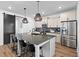 Spacious kitchen with a large island, stainless steel appliances, and modern fixtures at 304 Rivella Dr, Wake Forest, NC 27587