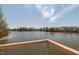 Scenic lake view featuring a deck with metal railing and a glimpse of neighborhood homes at 304 Rivella Dr, Wake Forest, NC 27587