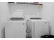 Bright laundry room with side-by-side white washer and dryer, and ample storage space at 304 Rivella Dr, Wake Forest, NC 27587