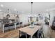 Open-concept living space with a kitchen island, dining area, and a comfortable living room area at 304 Rivella Dr, Wake Forest, NC 27587