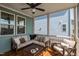 Inviting screened porch with a ceiling fan, lots of seating, and natural sunlight at 304 Rivella Dr, Wake Forest, NC 27587