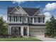 Charming two-story home showcasing a well-manicured lawn, complemented by an attached two-car garage and beautiful architectural details at 333 Parlier Dr, Cary, NC 27519