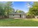 Large, fenced backyard with a lush lawn, mature trees, and a concrete patio at 3332 Apache Dr, Raleigh, NC 27609