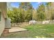 The backyard has mature trees, lawn and a utility building at 3332 Apache Dr, Raleigh, NC 27609