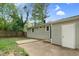 A view of the backyard with a concrete patio and a building at 3332 Apache Dr, Raleigh, NC 27609